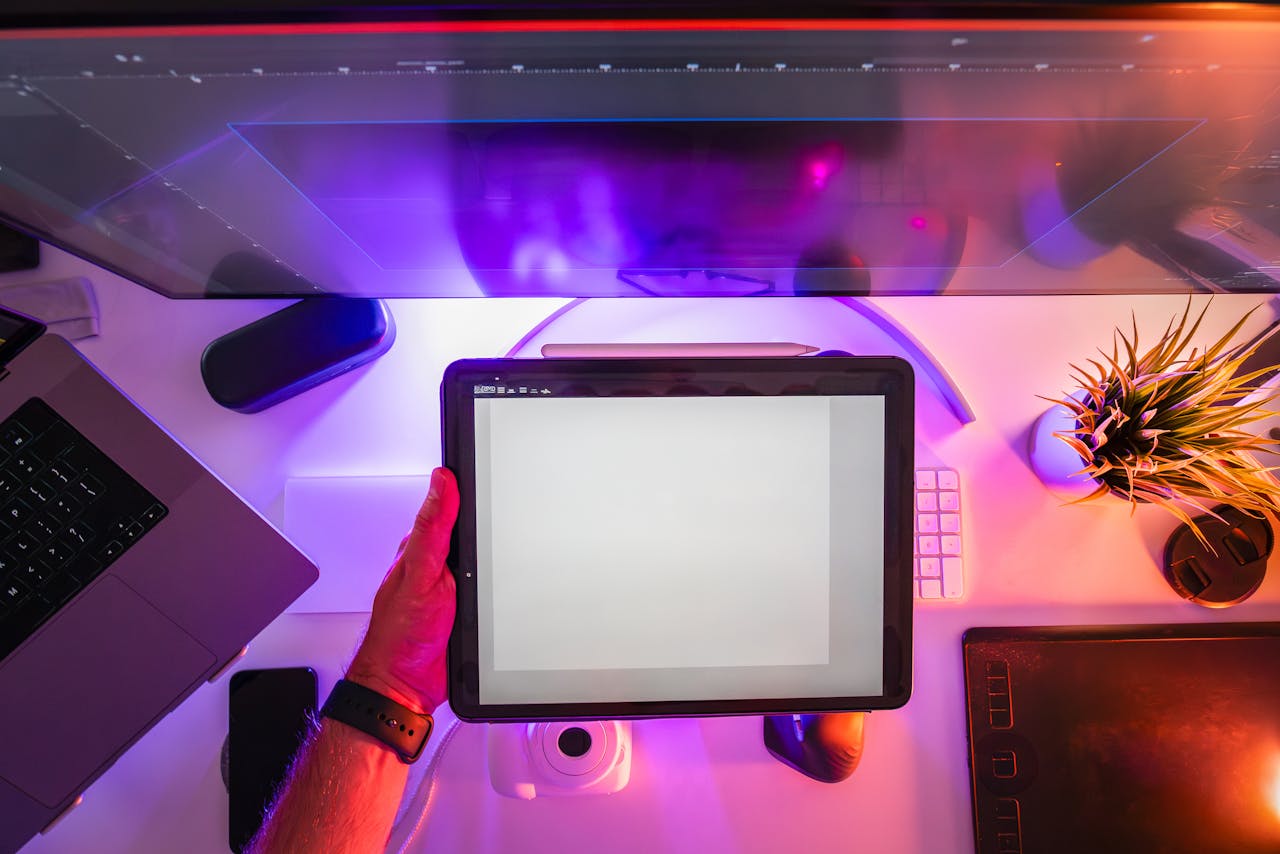 why-choose-us A vibrant workspace featuring a digital tablet and neon lighting, ideal for designers or photographers.
