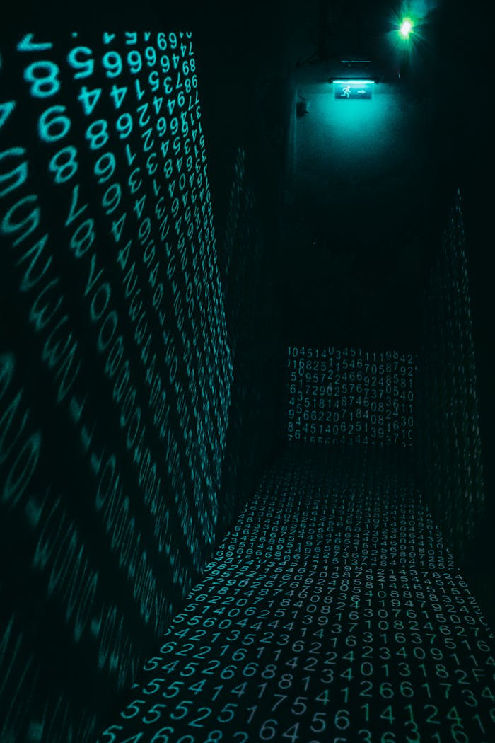 gallery-4 A dark hallway illuminated with neon digital number projections, creating a cyberpunk ambiance.